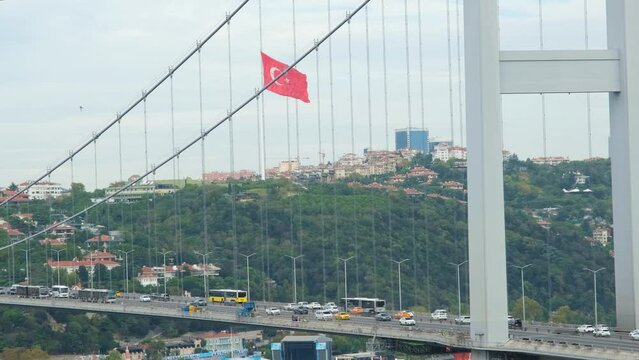 Bosphorus bridge from Nakkastepe park, 15 July Martyrs Bridge with cars and Turkish flag, 15 Temmuz Köprüsü in Turkish, transportation idea, cityscape video: Nakkastepe, Istanbul, Turkey - 09.10.22