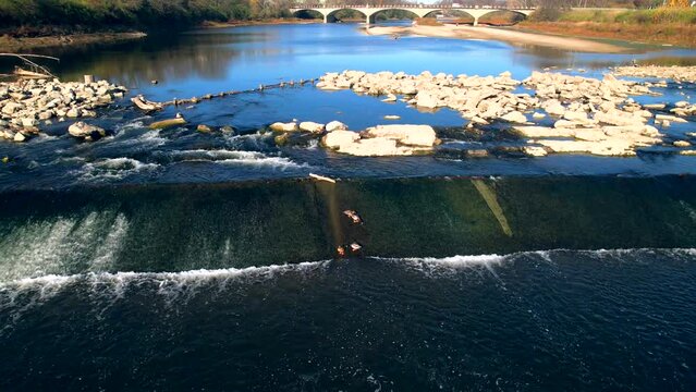 Aerial drone view of ducks in white river water at Belmont Beach with bridge in background Indianapolis, IN