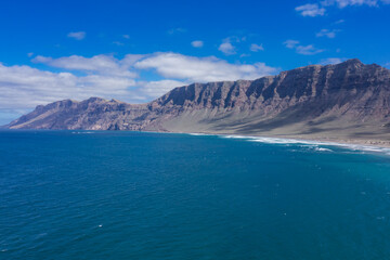 Fototapeta na wymiar Panorama of the empty road through sandy and volcanic desert