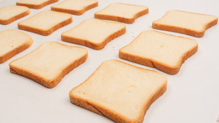 Delicious bread slices isolated on a white background, top view.