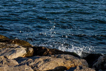 sea wave crashes on a rocky shore