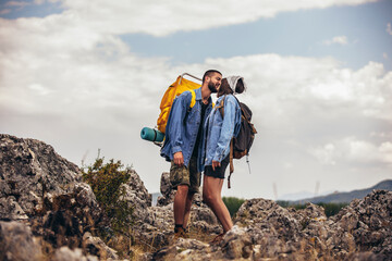 Beautiful couple of hikers in love are kissing enjoying in nature.