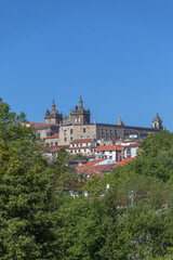 Fototapeta na wymiar View at the Viseu city, with Cathedral of Viseu on top, Se Cathedral de Viseu, architectural icons of the city behind de trees