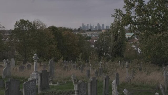 View of London Cityscape Financial District from Graveyard Cemetery During Economic Downturn