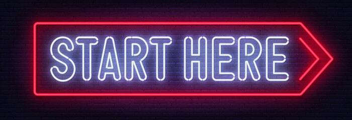 Start here neon sign on brick wall background.