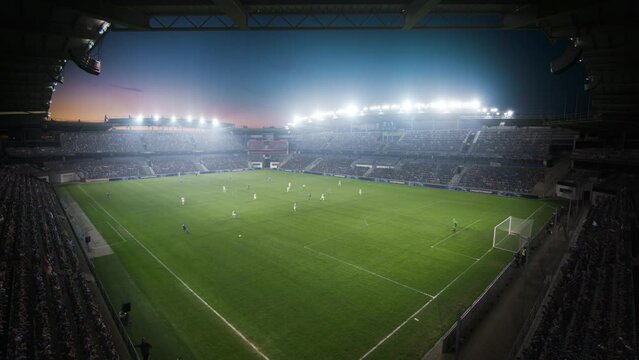 High Angle Establishing Shot: Stadium with Soccer Championship Match. Teams Play, Score Goal, Win Football Cup Tournament, Crowds of Fans Cheer. Sport Channel Playback. Static Wide Shot