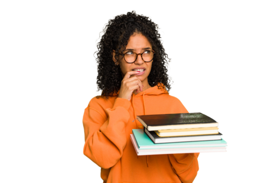 Young student woman holding a pile of books isolated relaxed thinking about something looking at a copy space.