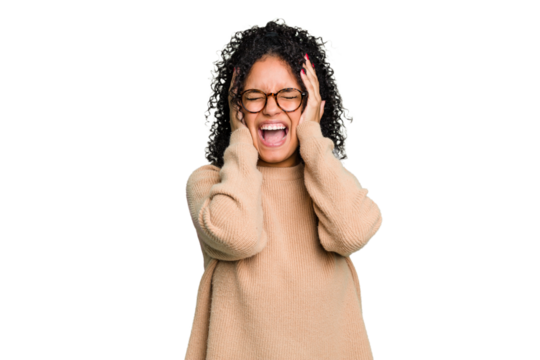 Young cute brazilian woman isolated covering ears with hands trying not to hear too loud sound.