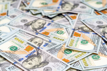 American money scattered on the desk. Pile of new design US dollar bills. Finance and economy concepts