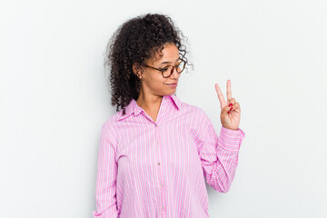 Young african american woman isolated joyful and carefree showing a peace symbol with fingers.