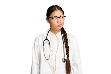 Young doctor asian woman isolated confused, feels doubtful and unsure.