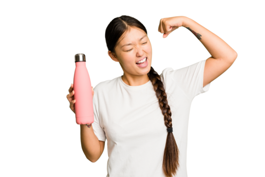 Young asian woman holding a pink thermo isolated raising fist after a victory, winner concept.