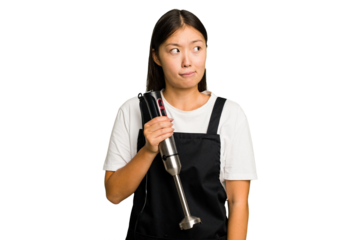 Young asian cook woman holding a blender isolated confused, feels doubtful and unsure.