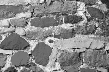 Rough ancient stone wall, colorless, black and white background