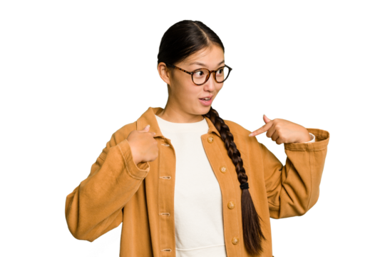Young Asian woman isolated surprised pointing with finger, smiling broadly.