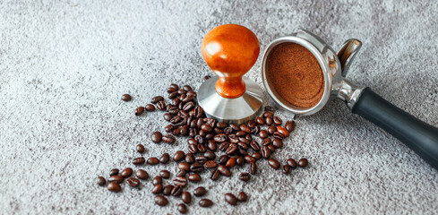 Equipment in a coffee shop of barista coffee tool portafilter with tamper and dark roasted coffee...