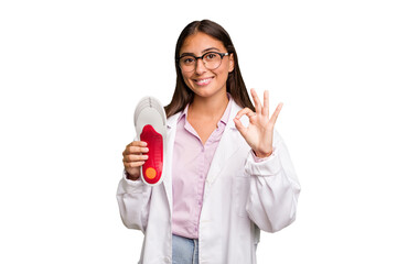 Young caucasian podiatrist woman isolated cheerful and confident showing ok gesture.