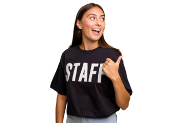 Young caucasian staff woman isolated points with thumb finger away, laughing and carefree.