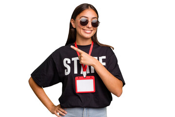 Young caucasian staff woman wearing a badge isolated smiling and pointing aside, showing something...