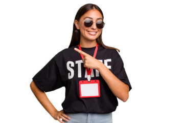 Young caucasian staff woman wearing a badge isolated smiling and pointing aside, showing something at blank space.