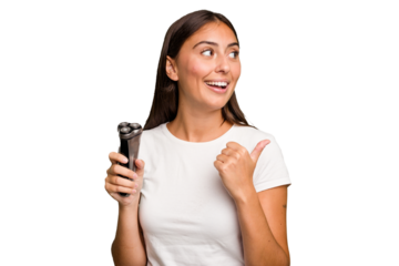 Young caucasian woman holding a razor isolated points with thumb finger away, laughing and carefree.