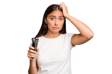 Young caucasian woman holding a razor isolated being shocked, she has remembered important meeting.