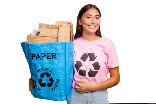 Young caucasian woman holding a recycling bag full of paper to recycle isolated laughing and having fun.