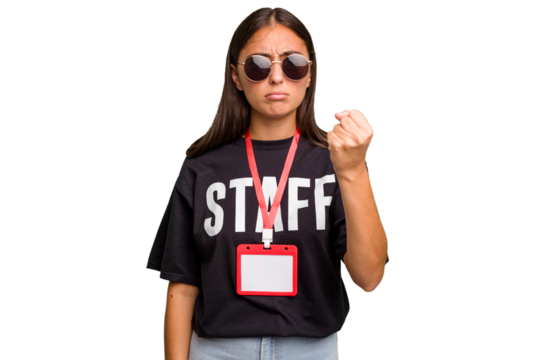 Young caucasian staff woman wearing a badge isolated showing fist to camera, aggressive facial expression.