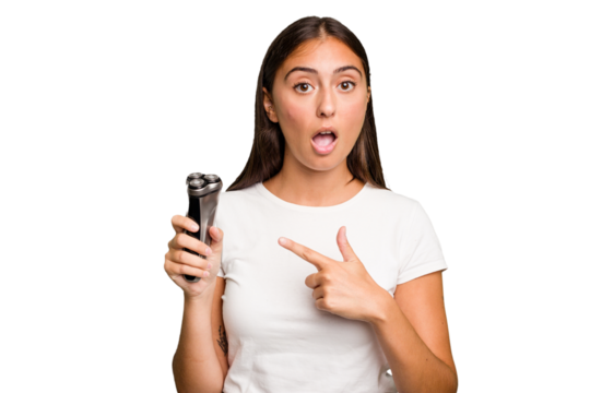 Young caucasian woman holding a razor isolated pointing to the side