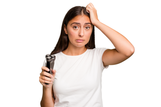 Young caucasian woman holding a razor isolated being shocked, she has remembered important meeting.