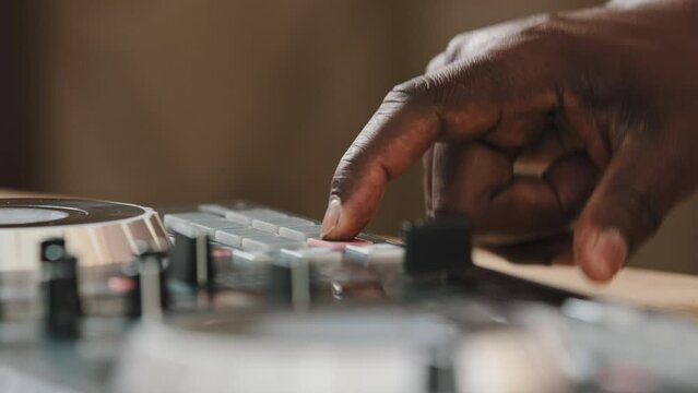 Unrecognizable African American DJ write music unknown man musician composer playing song audio at home club recording studio workshop creative new composition sound beat maker hit with male finger