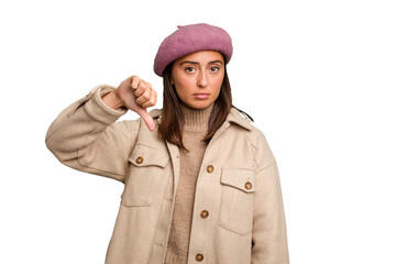 Fototapeta premium Young caucasian woman wearing winter jacket isolated showing a dislike gesture, thumbs down. Disagreement concept.