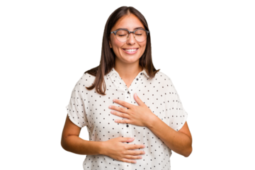 Young cute caucasian woman isolated laughs happily and has fun keeping hands on stomach.