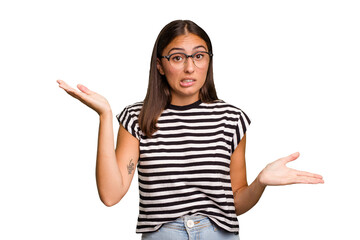 Young cute caucasian woman isolated confused and doubtful shrugging shoulders to hold a copy space.