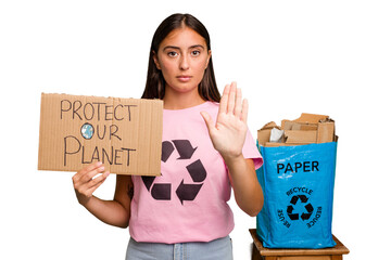 Young caucasian recycler woman holding a protect our planet placard isolated