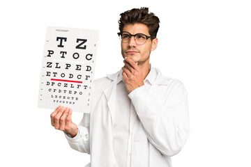 Young caucasian oculist man isolated looking sideways with doubtful and skeptical expression.