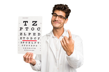 Young caucasian oculist man isolated pointing with finger at you as if inviting come closer.