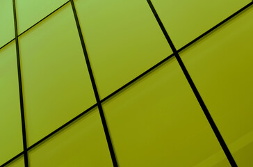 Yellow glass panels of the facade of a modern building