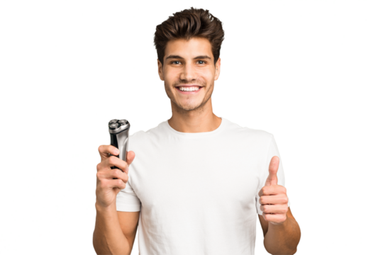 Young caucasian man holding a razor isolated smiling and raising thumb up