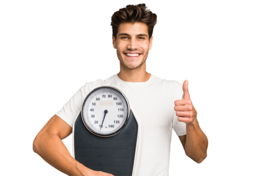 Young caucasian man holding a scale isolated smiling and raising thumb up
