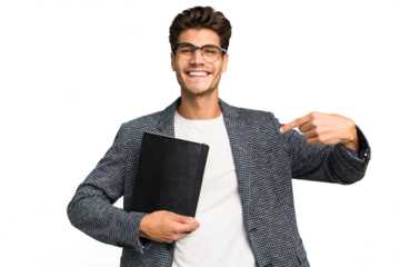 Young teacher caucasian man holding a book isolated person pointing by hand to a shirt copy space, proud and confident