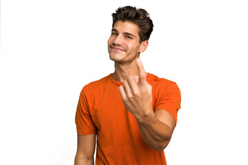 Young caucasian handsome man isolated pointing with finger at you as if inviting come closer.
