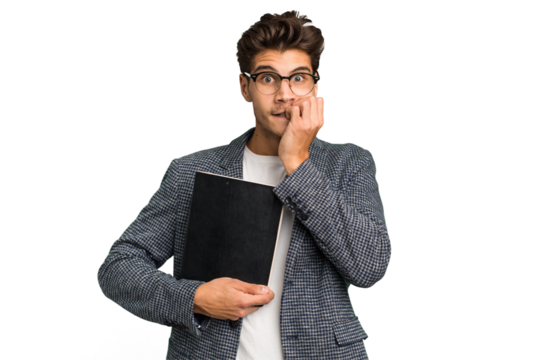 Young teacher caucasian man holding a book isolated biting fingernails, nervous and very anxious.