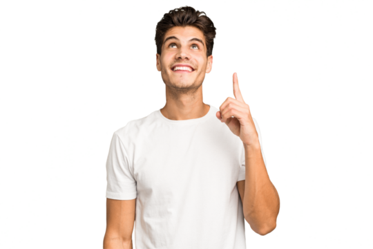 Young caucasian handsome man isolated indicates with both fore fingers up showing a blank space.