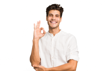 Young caucasian handsome man isolated winks an eye and holds an okay gesture with hand.