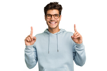 Young caucasian handsome man isolated indicates with both fore fingers up showing a blank space.
