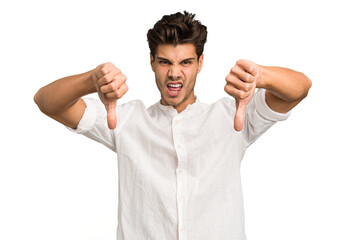 Fototapeta premium Young caucasian handsome man isolated showing thumb down and expressing dislike.