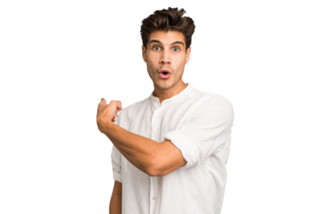 Young caucasian handsome man isolated smiling and pointing aside, showing something at blank space.