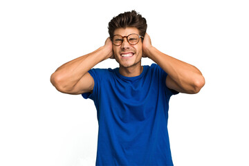 Young caucasian handsome man isolated covering ears with hands.
