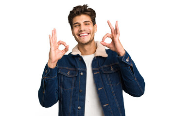 Young caucasian handsome man isolated cheerful and confident showing ok gesture.